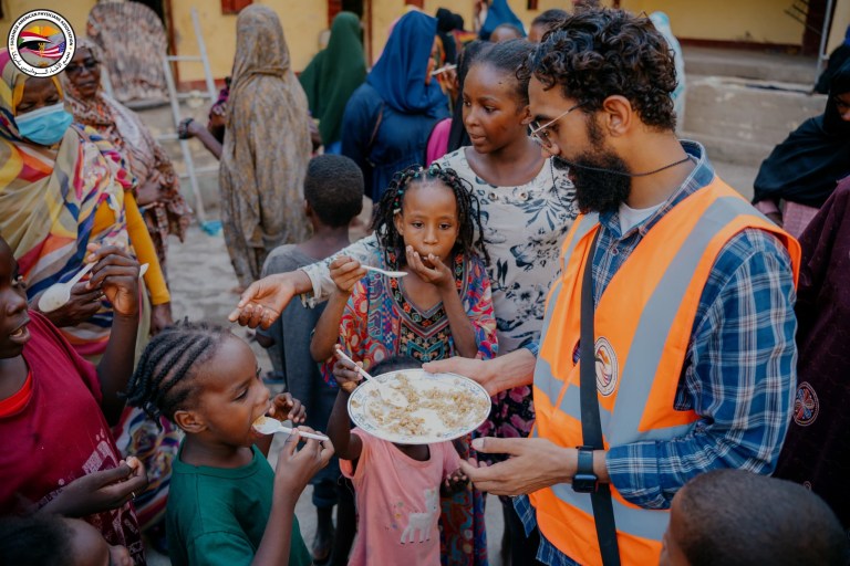 SAPA volunteer feeding the locals during Sudan food crisis