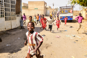 sudanese children running and playing in the streets