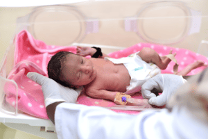a newborn in sudan being helped by sapa and embrace